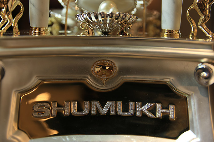 Most diamonds set on a perfume bottle Shumukh logo