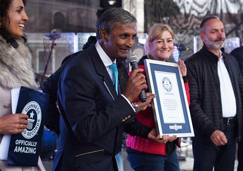 Adjudicator-holding-certificate-with-record-breaker