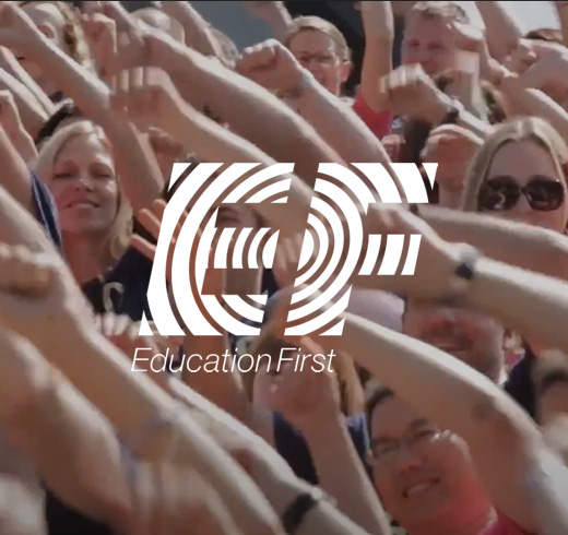 Education first logo above a picture of people waving their hands