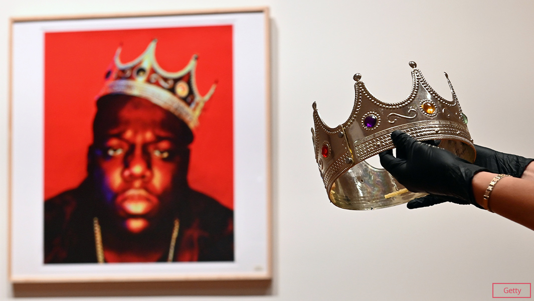 portrait of notorious BIG with someone holding plastic crown