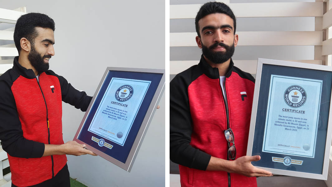 Ali Mounir holding his certificate after breaking the record for most jump squats in one minute