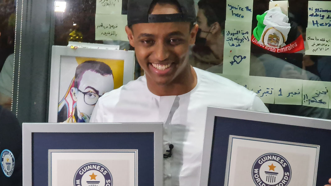 AboFlah holding his certificates after breaking two world records