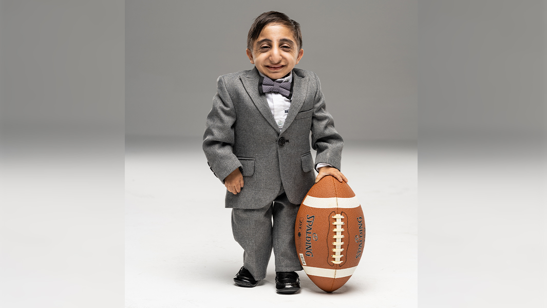 split image of worlds shortest man being measured and sitting on a basketball