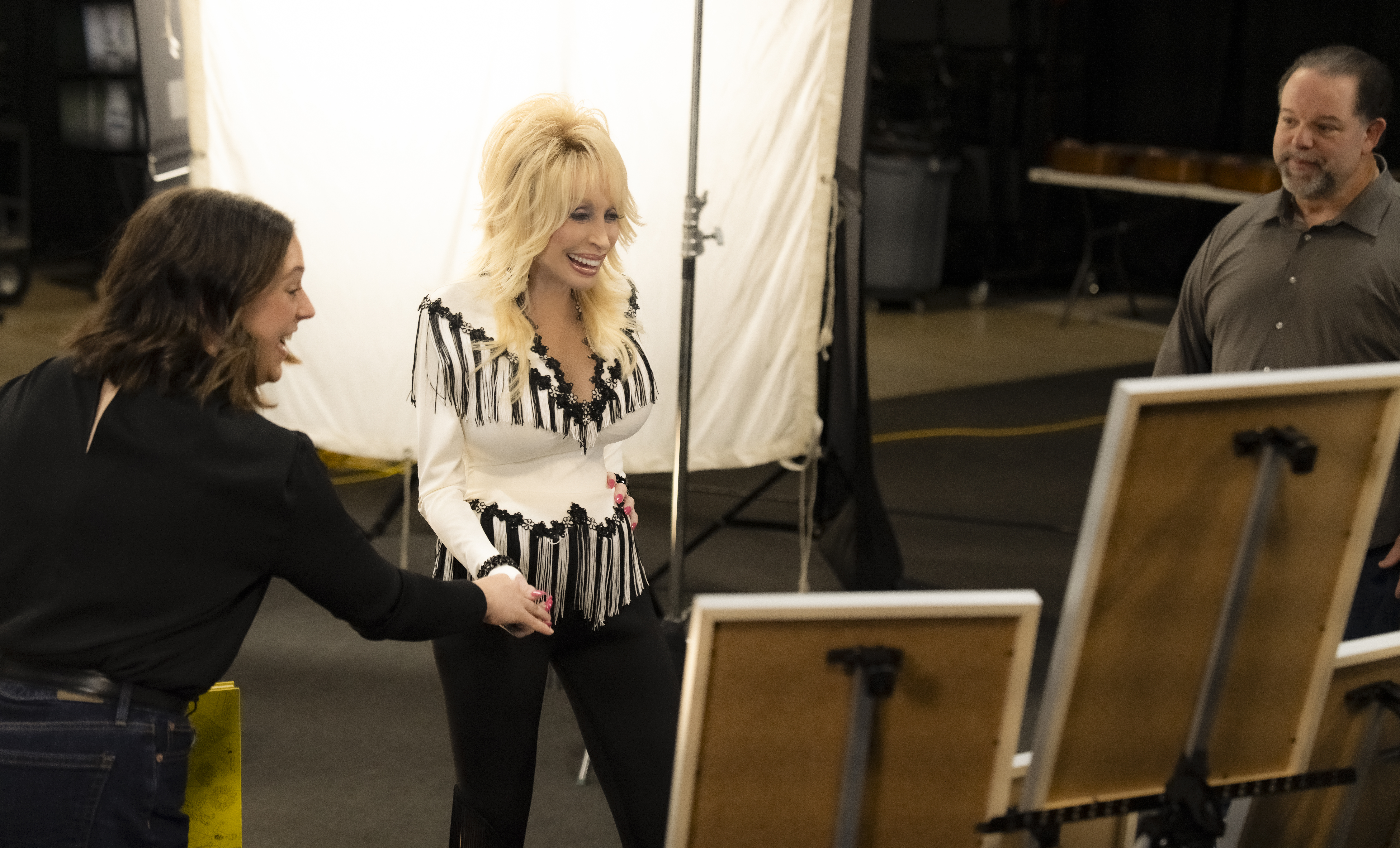 Dolly looking at her certificates 
